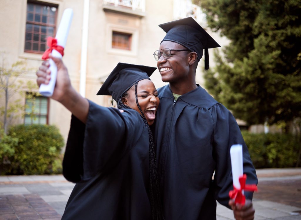 Black students, hug and celebration for graduation, education and achievement on university, campus