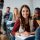 Happy female student learning in the classroom and looking at camera. Happy female student learning in the classroom and looking at camera.