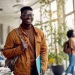 Portrait of happy African American student in a hallway looking at camera. Portrait of happy African American student in a hallway looking at camera.